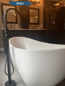 An image labeled "After." A deep soaking bathtub is seen with a two sink counter in the background. Faucet finished are dark brass.
