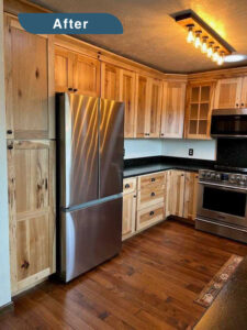 An after picture of a kitchen remodel in Evergreen, showing refrigerator and wood cabinets.